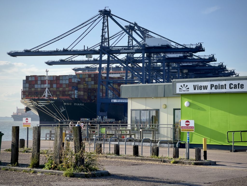 An angle showing View Point Cafe in the foreground, with a container ship in Felixstowe port in the background.