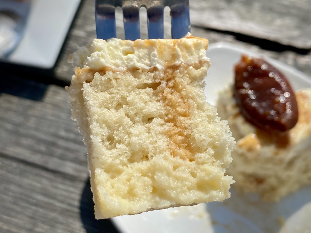 A close-up of a fork with a slice of 'Tres Leches' Mexican pudding.