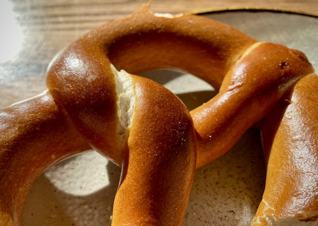 A close up of a German Pretzel, showing the shining skin and classic Pretzel knot.