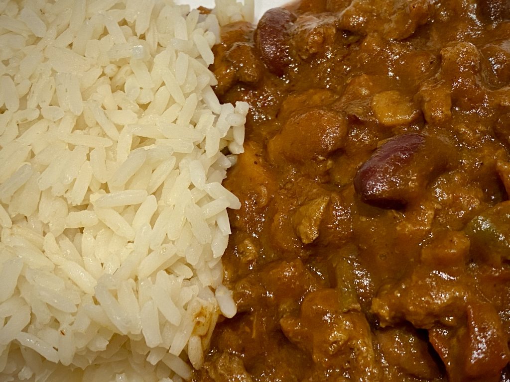 A close up shot of a chilli con carne and rice.